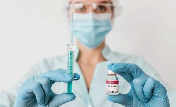 Free Holding Vaccine Vial Mockups